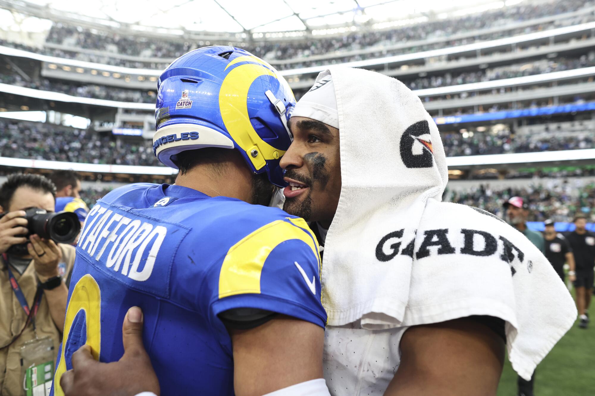 Rams quarterback Matthew Stafford, left, and Eagles quarterback Jalen Hurts meet after their game in 2023.