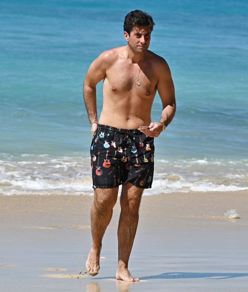 James Argent walking on a beach in Barbados.