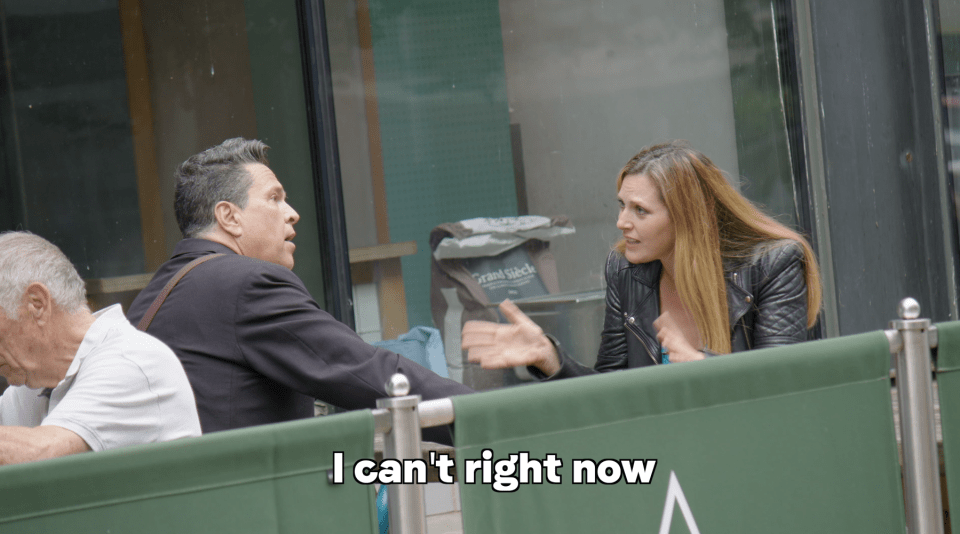 A man and woman arguing at an outdoor cafe; text overlay reads "I can't right now."