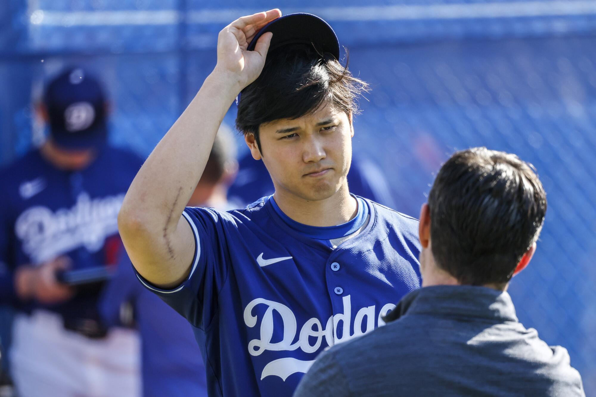 Dodgers DH Shohei Ohtani talks with president of baseball operations Andrew Friedman during spring training last year.