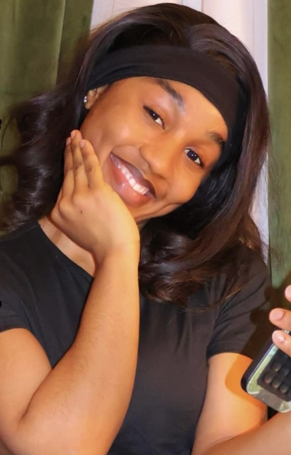 Close-up of a smiling pregnant woman with a headband.