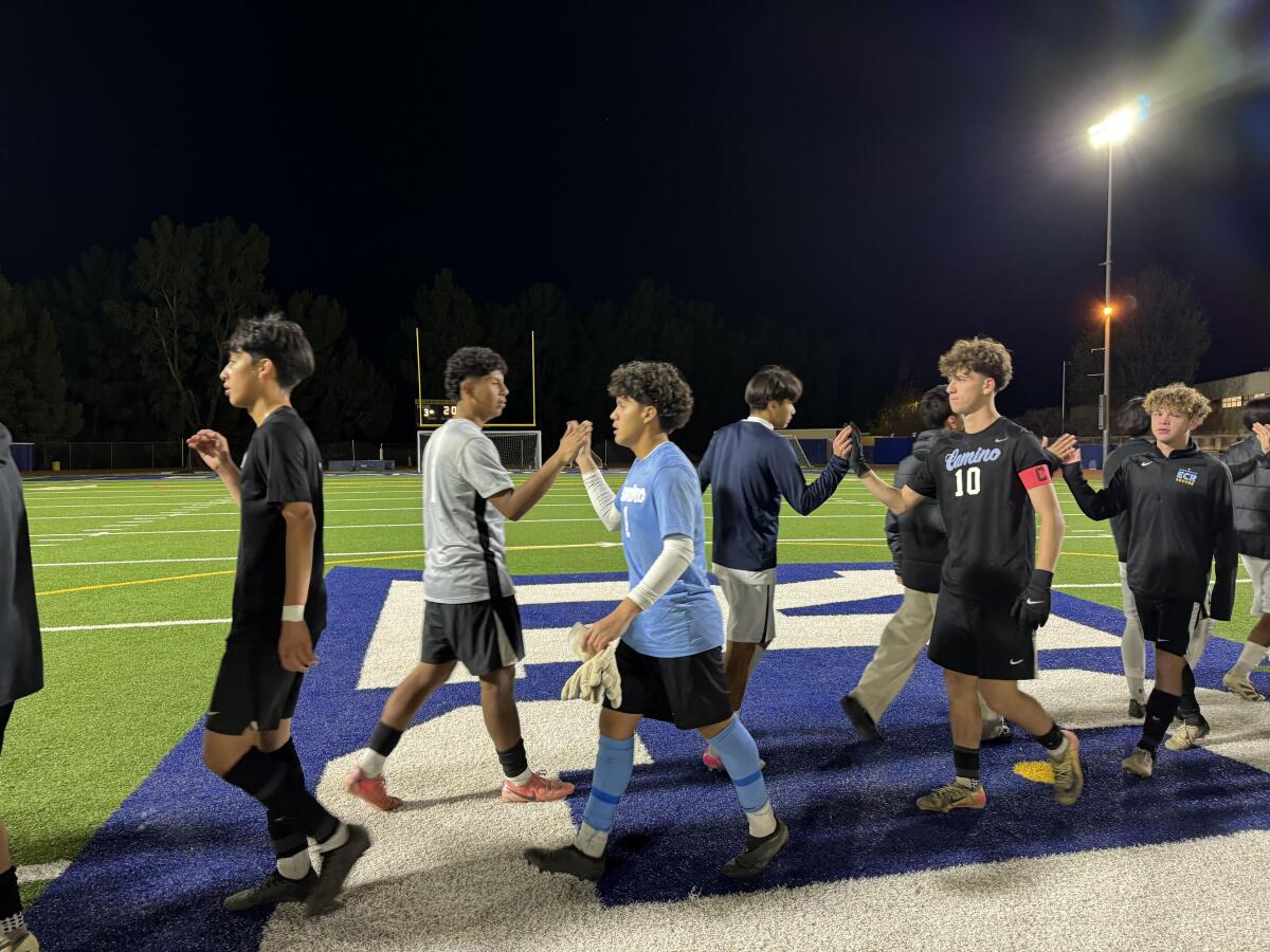 El Camino Real goalie Anthony Salmeron (1) and teammate Jonathan Rabinovitch (10) shake hands with Birmingham players.