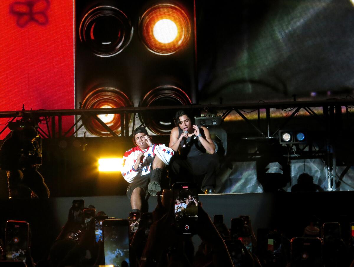 Emilio de la Rosa, left, and Milton de la Rosa of the band Latin Mafia perform in concert.