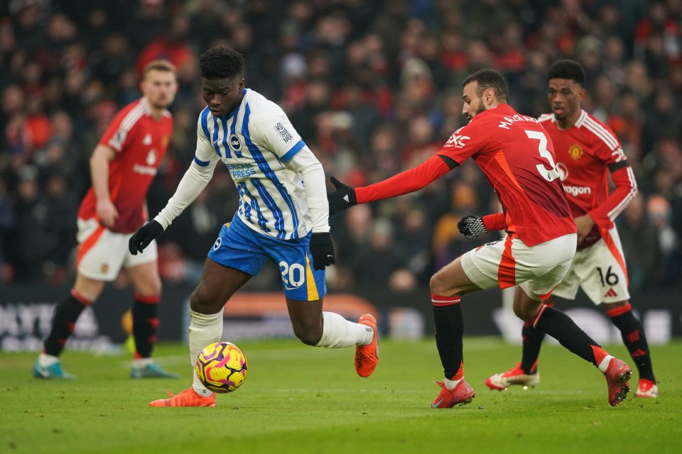 Brighton's Carlos Baleba and Manchester United's Noussair Mazraoui vying for the ball.