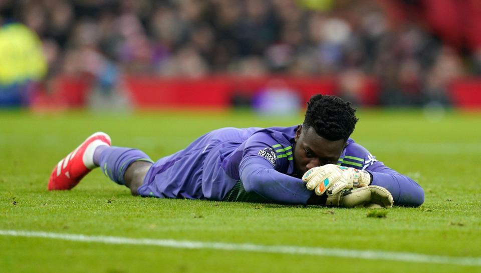 Andre Onana of Manchester United lying on the field.