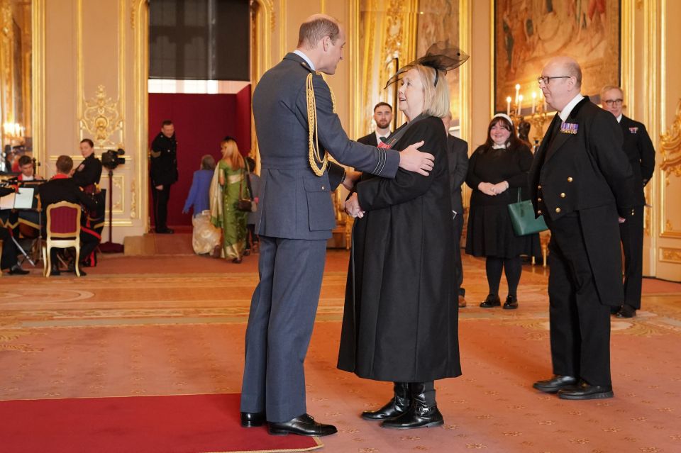 Prince William presenting Pauline Quirke with an MBE at Windsor Castle.