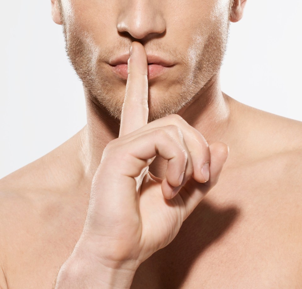 Man holding finger to his lips, shushing.