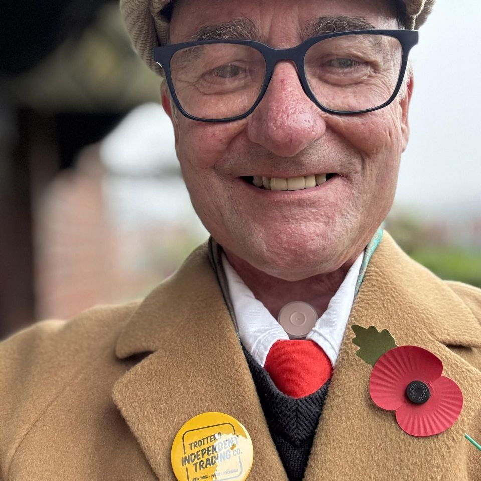 Portrait of a man with a stoma, wearing glasses and a poppy.