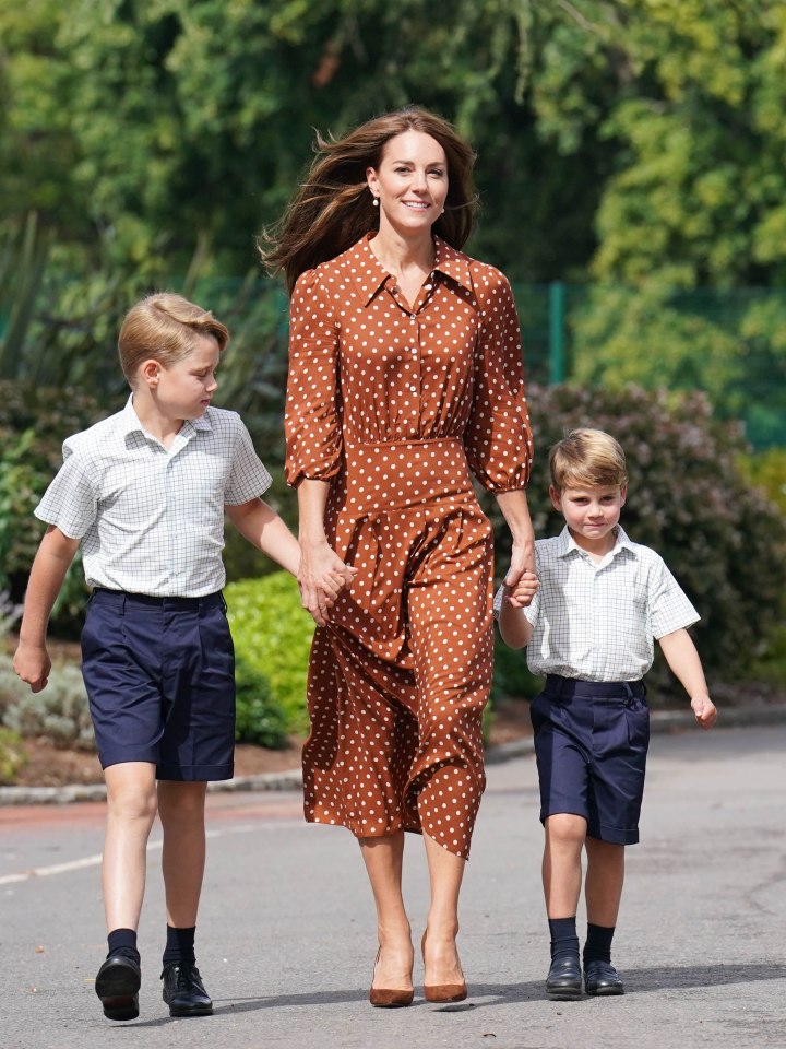 Catherine, Duchess of Cambridge, walking with Prince George and Prince Louis.