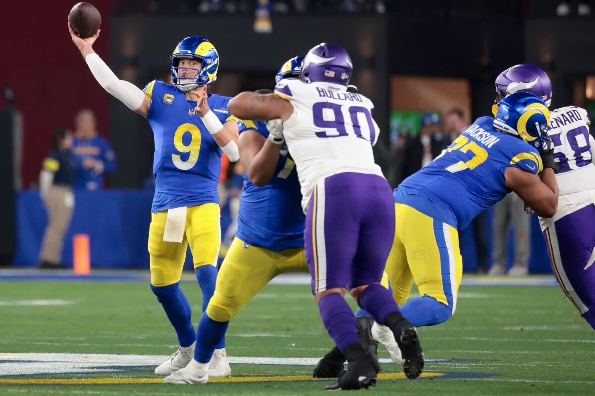 Rams quarterback Matthew Stafford throws a pass during the first quarter of the playoff game against the Vikings.