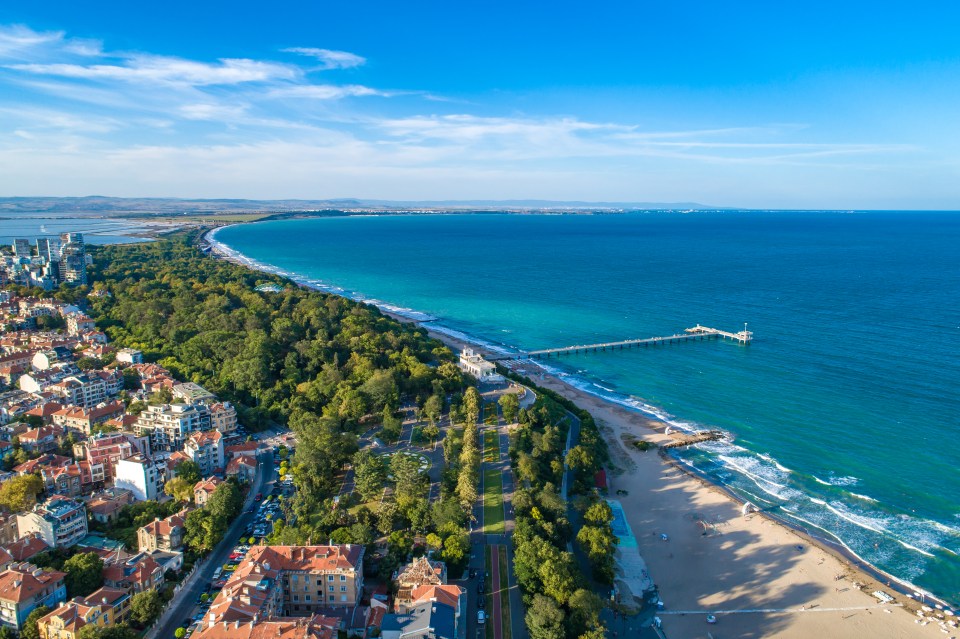 Aerial view of Burgas, Bulgaria, showing the coastline, sea, and city.