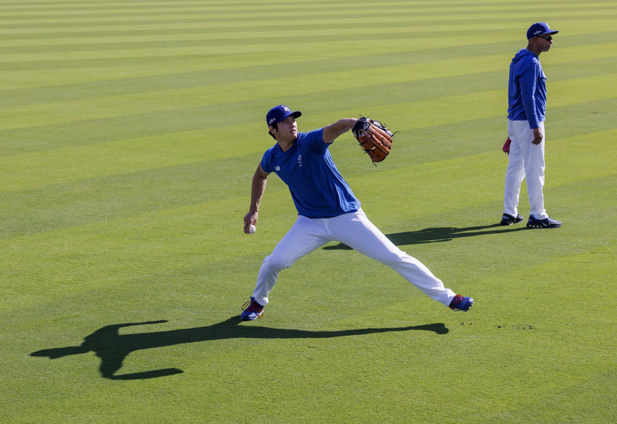 The Dodgers' Shohei Ohtani throwing in the outfield before Game 5 of the NLDS against the Padres last season.