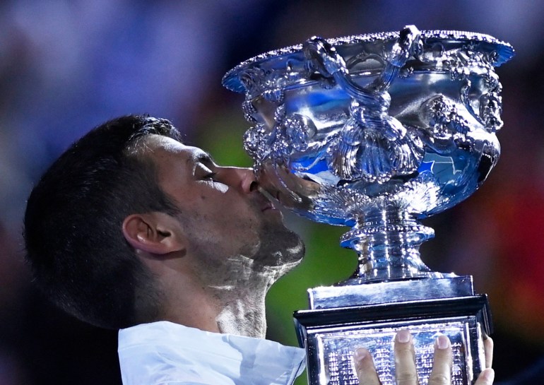 Tennis - Australian Open - Men's Singles Final - Melbourne Park, Melbourne, Australia - January 29, 2023 Serbia's Novak Djokovic celebrates with the trophy after winning his final match against Greece's Stefanos