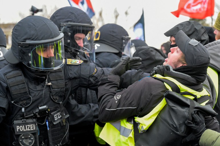 Police officer clashes with activist outside an AfD convention in Germany