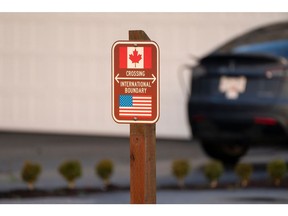 A sign marks the international boundary between Canada and the United States in Blaine, Washington, US, on Wednesday, Dec. 18, 2024. Canada's trade surplus with the US helped the northern nation avoid a deeper overall deficit, underscoring the importance of its biggest trading partner as President-elect Donald Trump threatens crippling tariffs.