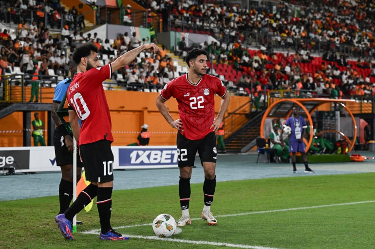 Egypt's forward #10 Mohamed Salah gestures as Egypt's forward #22 Omar Marmoush reacts during the Africa Cup of Nations (CAN) 2024 group B football match between Egypt and Ghana at the Felix Houphouet-Boigny Stadium in Abidjan on January 18, 2024. (Photo by Issouf SANOGO / AFP)