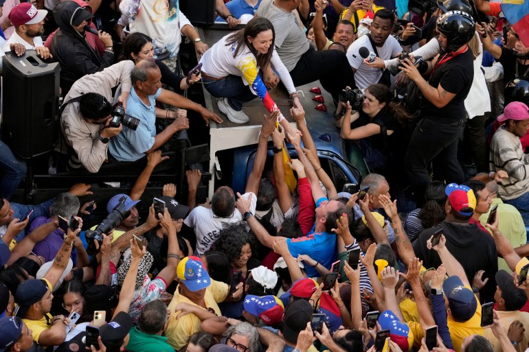 Maria Corina Machado greets a crowd of supporters on January 9