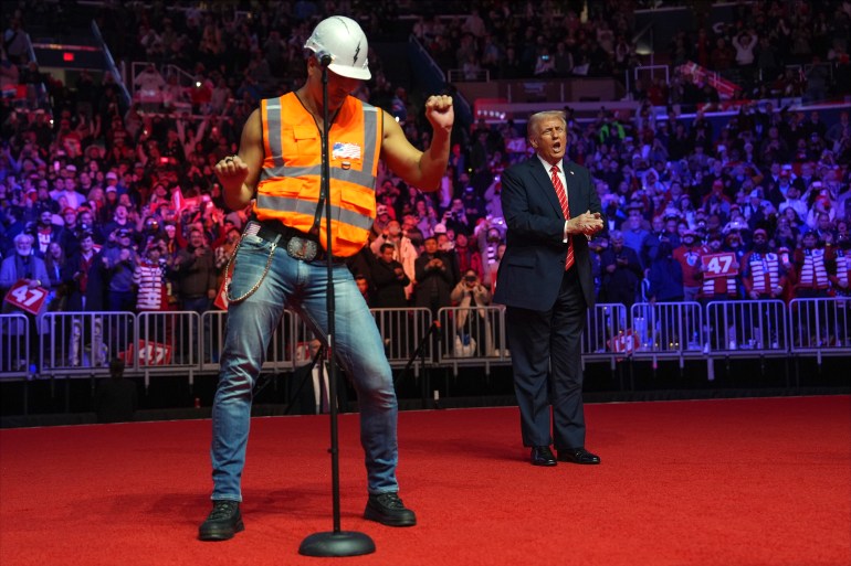 President-elect Donald Trump dances with The Village People at a rally ahead of the 60th Presidential Inauguration, Sunday, Jan. 19, 2025, in Washington. (AP Photo/Evan Vucci)