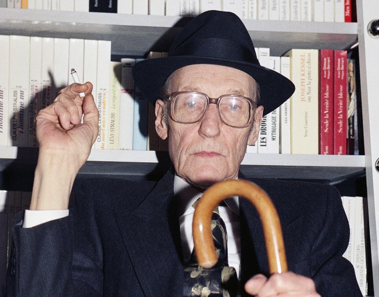 American writer William Seward Burroughs smoking a cigarette and holding a walking stick around March 23, 1990. (AP Photo)