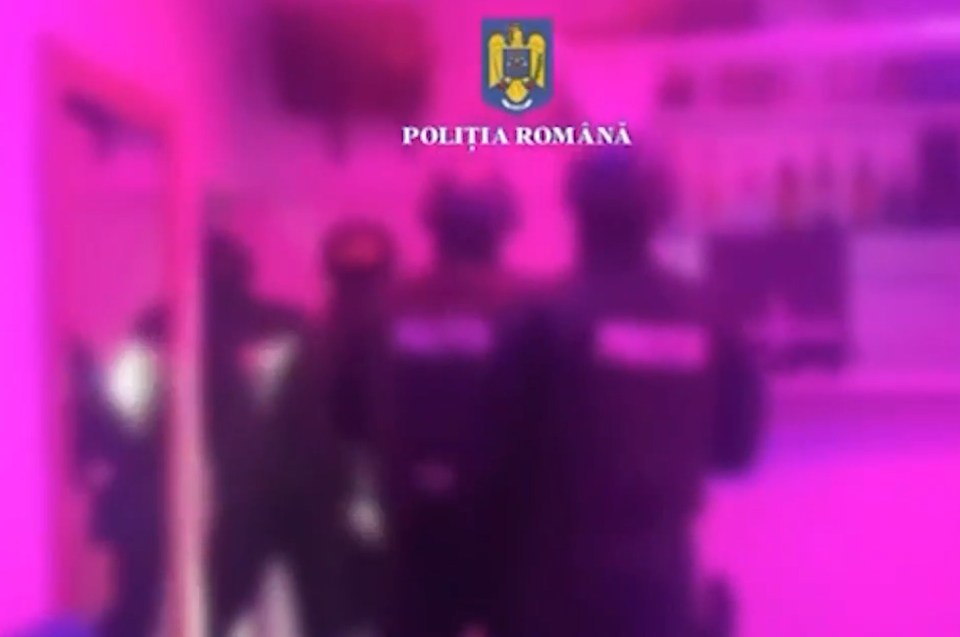 Blurred image of Romanian police officers in a room.