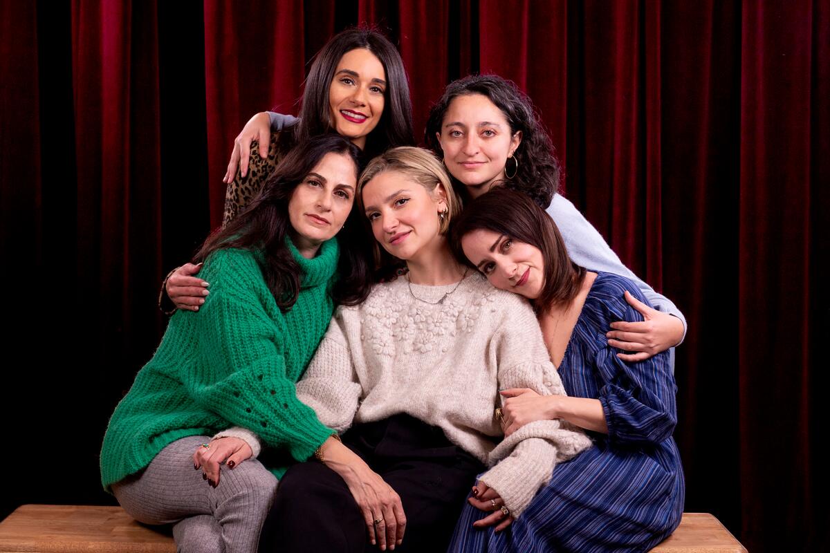 Five women posing together