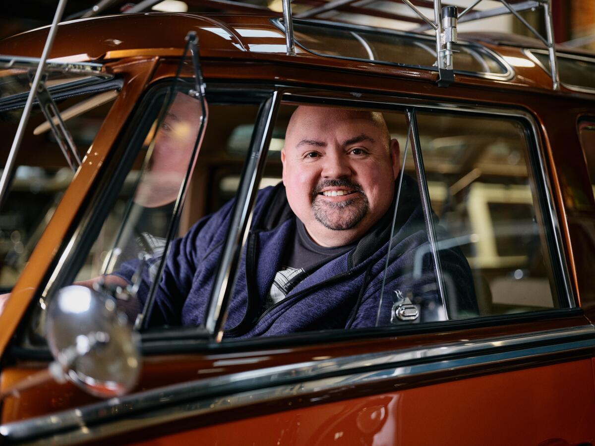 Gabriel Iglesias smiles from inside a car.