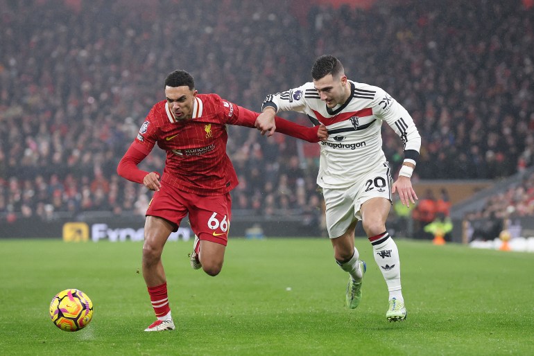 LIVERPOOL, ENGLAND - JANUARY 05: Trent Alexander-Arnold of Liverpool in action against Diogo Dalot of Manchester United during the Premier League match between Liverpool FC and Manchester United FC at Anfield on January 05, 2025 in Liverpool, England. (Photo by Alex Livesey - Danehouse/Getty Images)