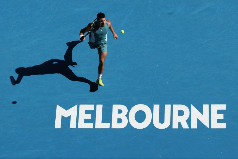 MELBOURNE, AUSTRALIA - JANUARY 17: Carlos Alcaraz of Spain chases the ball to return against Nuno Borges of Portugal in the Men's Singles Third Round match during day six of the 2025 Australian Open at Melbourne Park on January 17, 2025 in Melbourne, Australia. (Photo by Cameron Spencer/Getty Images)