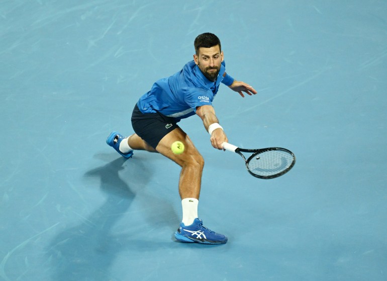 MELBOURNE, AUSTRALIA - JANUARY 17: Novak Djokovic of Serbia plays a backhand against Tomas Machac of the Czech Republic in the Men's Singles Third Round match during day six of the 2025 Australian Open at Melbourne Park on January 17, 2025 in Melbourne, Australia. (Photo by Quinn Rooney/Getty Images)