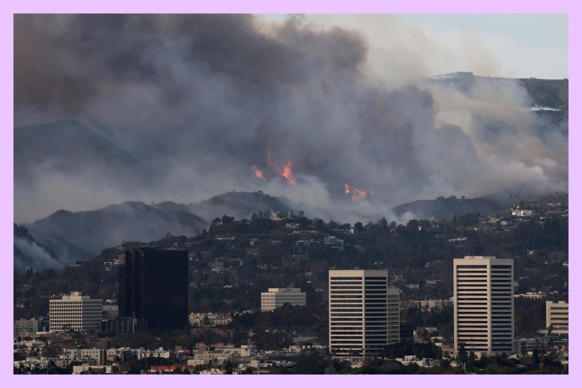 Smoke rises from distant hills and canyons in Los Angeles.