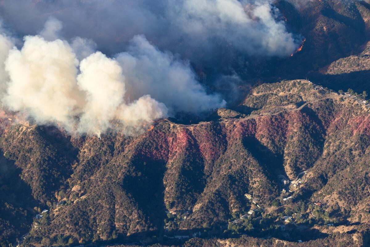 Helicopter aerial view of the Palisades fire burning above homes on Mandeville Canyon Road (bottom right) in Brentwood.