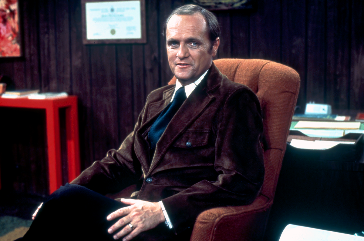 Bob Newhart in a suit sitting in an armchair.