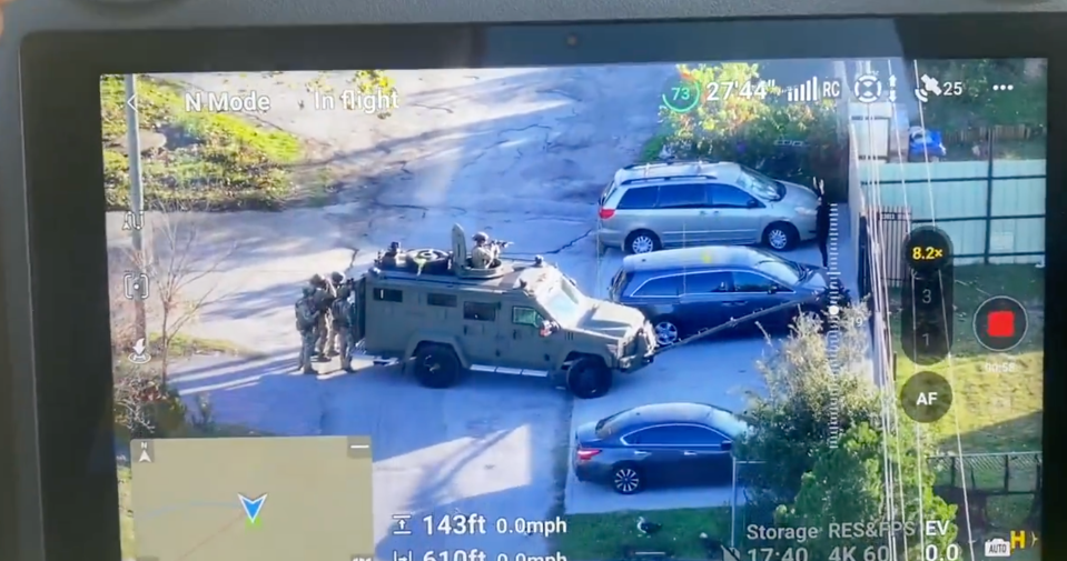 Swat officers are captured giving instructions to the unknown man