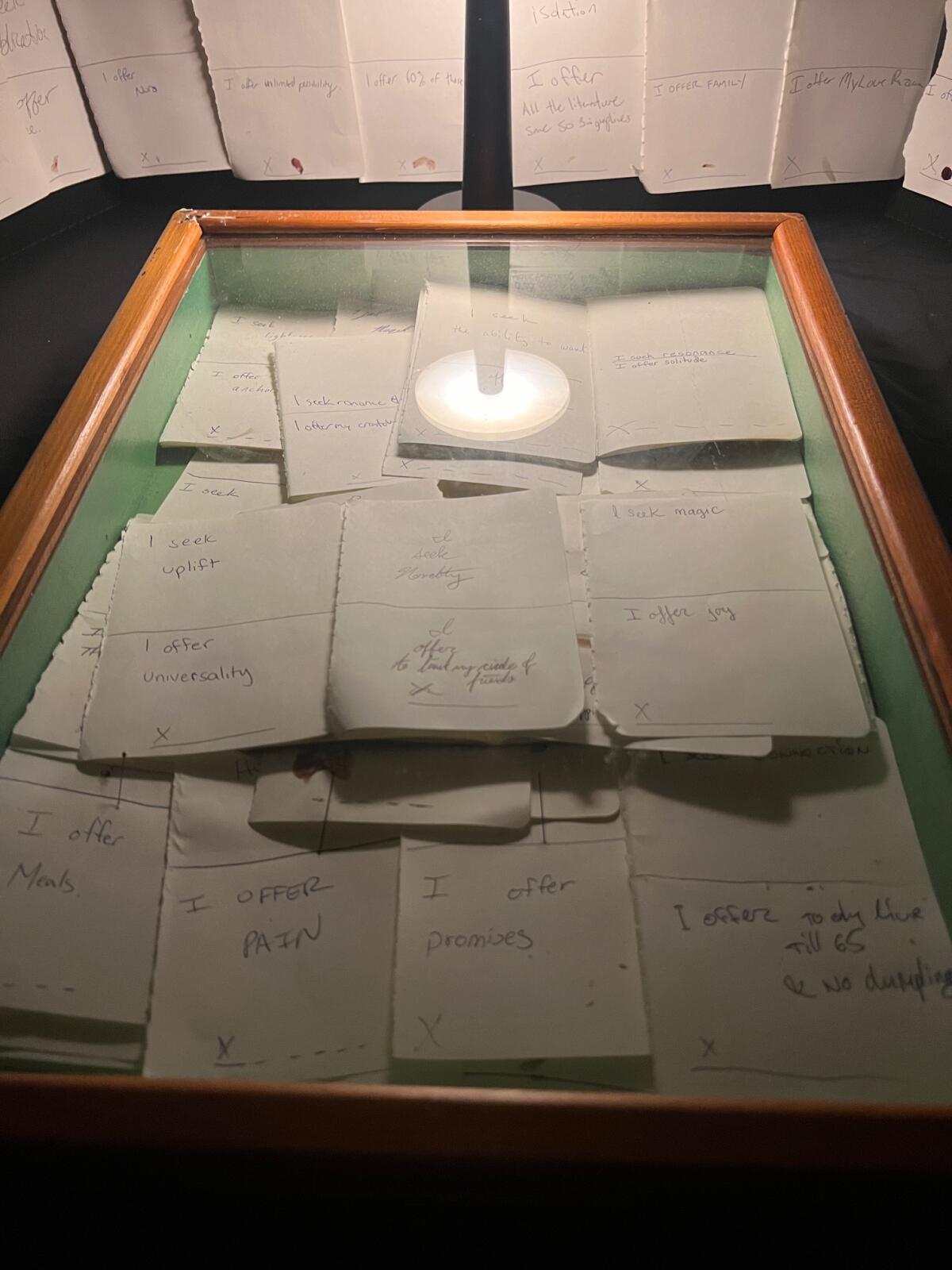 A glass case filled with notecards. 