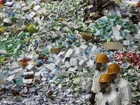 FILE - Workers prepare to destroy over 50 tons of confiscated fake medicine during a campaign to mark World Consumer Rights Day in Beijing, Thursday March 15, 2012. (AP Photo/File)