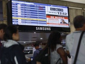 A wanted sign of Venezuelan opposition leader Edmundo Gonzalez is displayed on the list of departure flights at the Simon Bolivar International Airport in Maiquetia, near Caracas, Venezuela, Friday, Jan. 3, 2025.