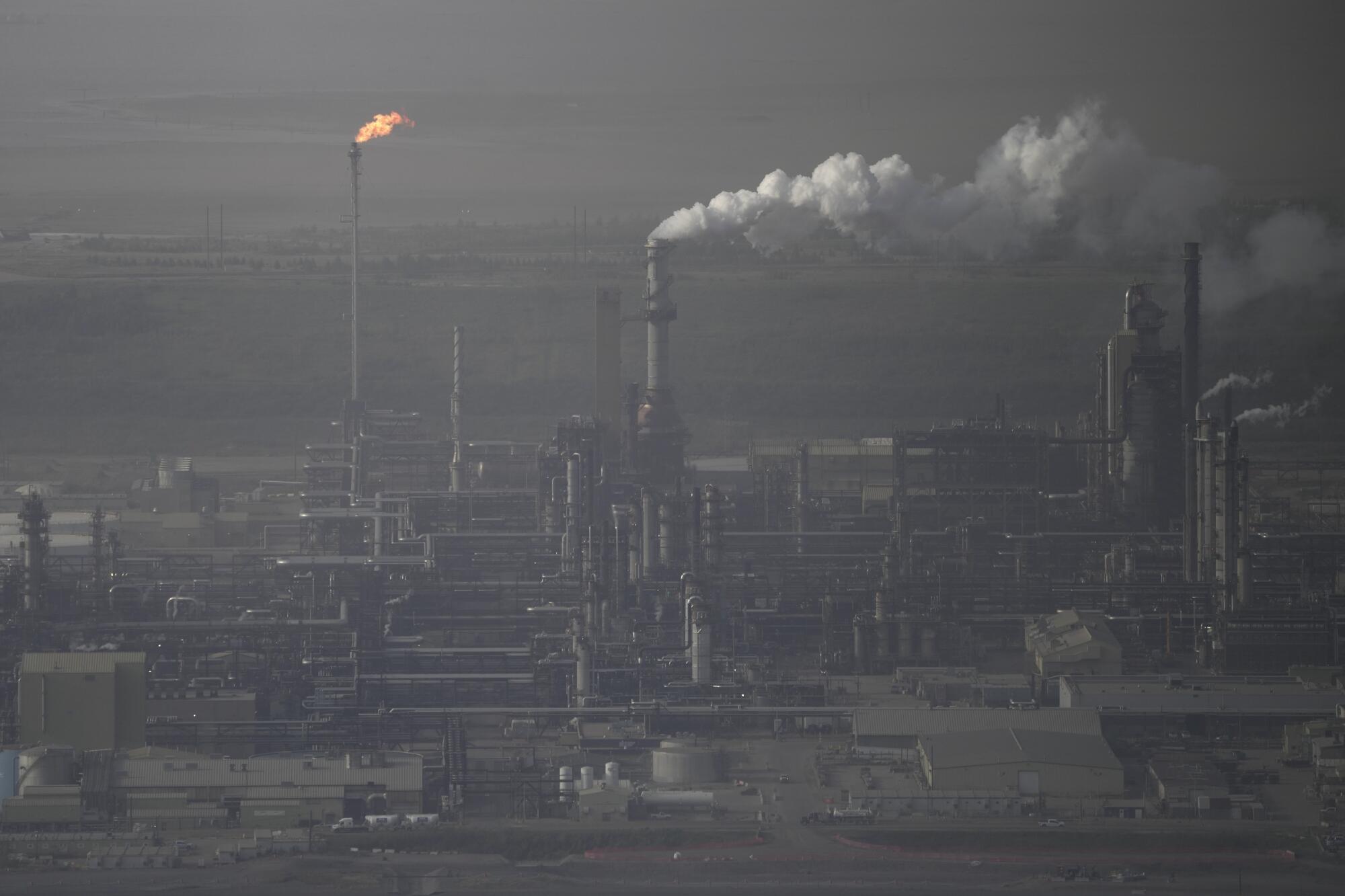 Steam rises at an oil sands facility near Fort McMurray, Canada.