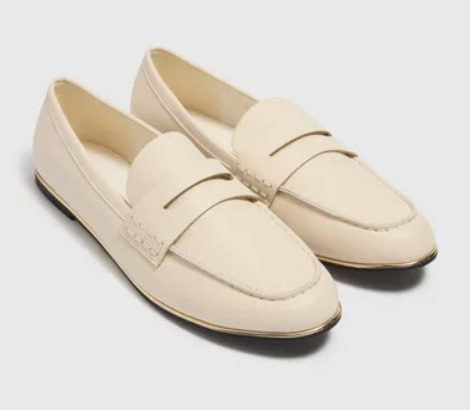 Pair of cream-colored leather loafers.