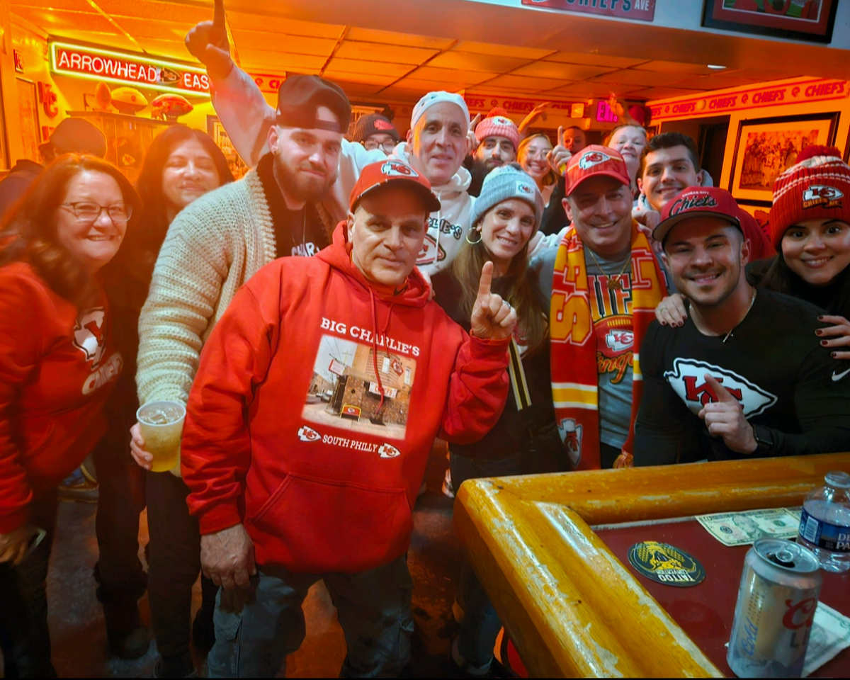 Big Charlie's Saloon owner Paul Staico, center with finger up, gathers with patrons at his South Philadelphia bar.