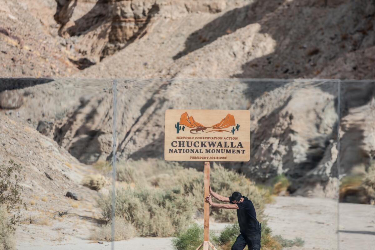 A worker takes down a Chuckwalla National Monument sign on Jan. 7 at the Mecca Hills Wilderness.