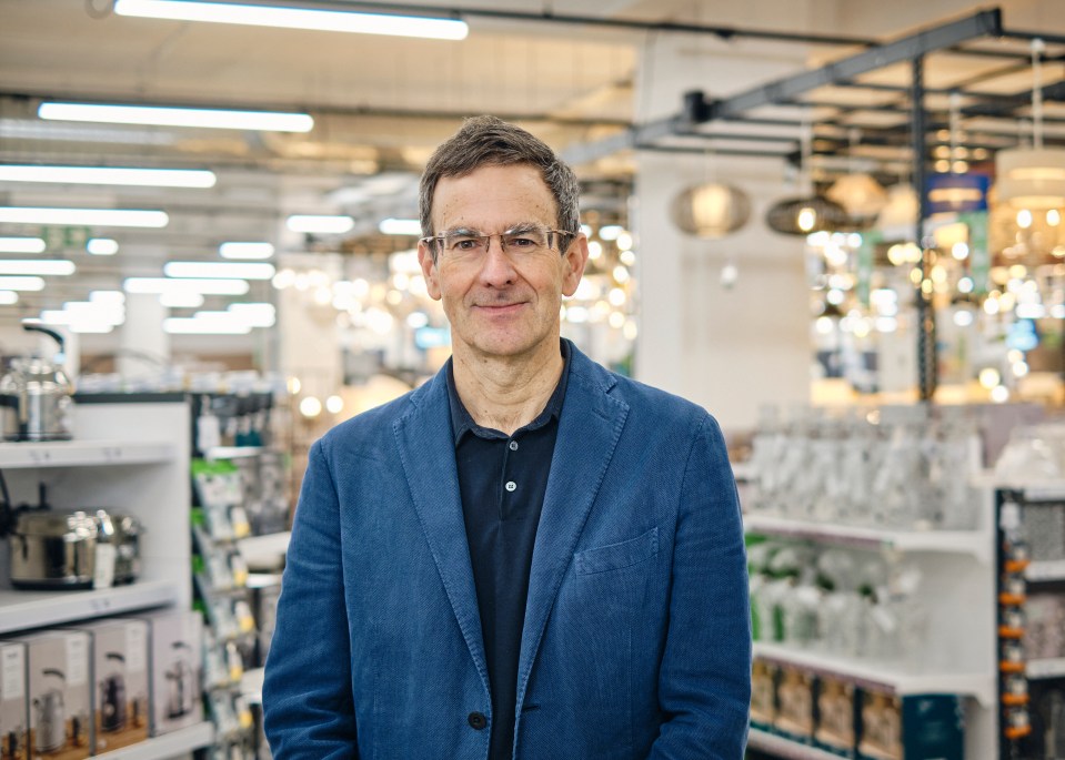 Portrait of Nick Wilkinson, CEO of Dunelm, in a home goods store.