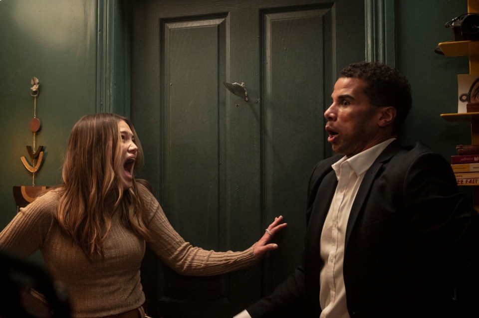 Film still of Olivia Holt and Mason Gooding reacting to a knife stuck in a door.