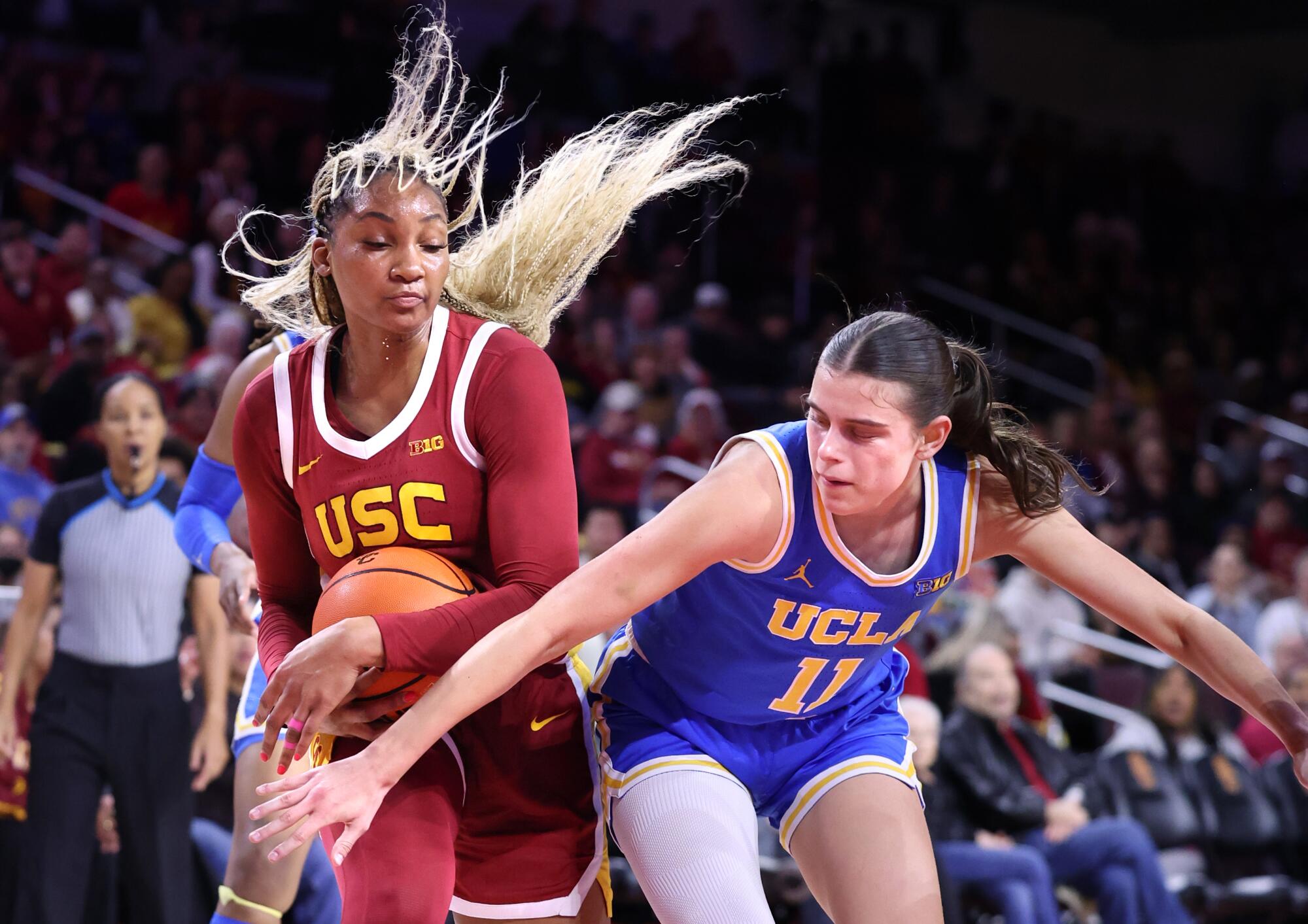 USC's Kiki Iriafen grabs a loose ball in front of UCLA's Gabriela Jaquez in the first quarter Thursday.