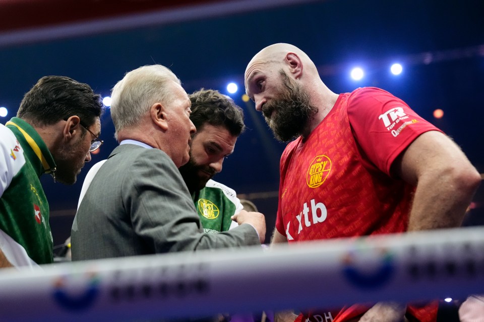 Tyson Fury with Frank Warren and others after a boxing match.