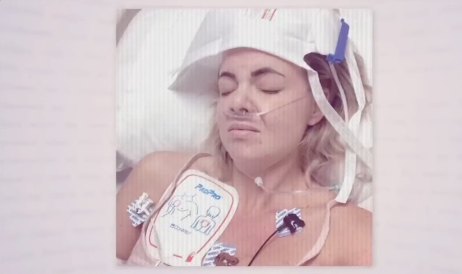 Woman in hospital bed with medical equipment.