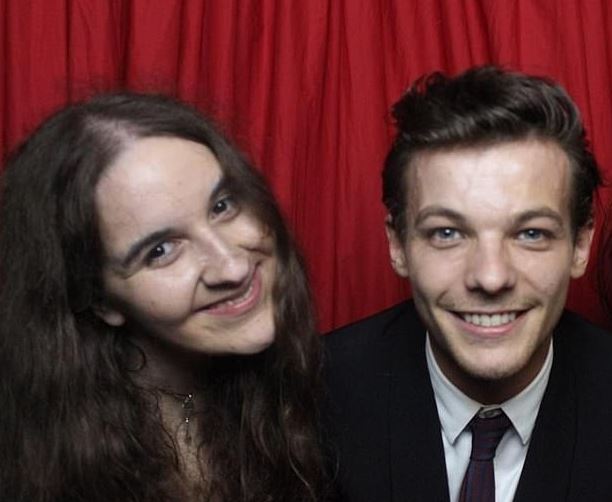 Photo booth picture of Megan Bhari and Louis Tomlinson.