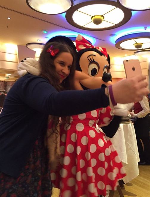 Woman taking a selfie with Minnie Mouse.