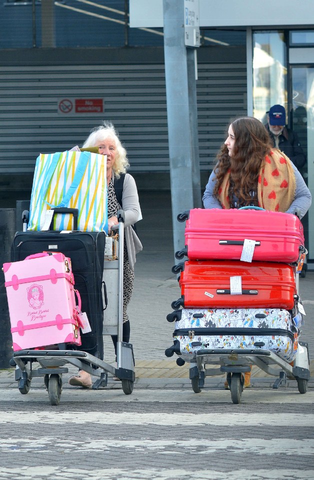 Two women with luggage carts at Southampton.