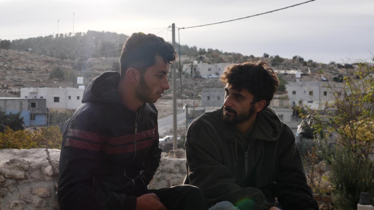 Two men have a discussion in the West Bank.