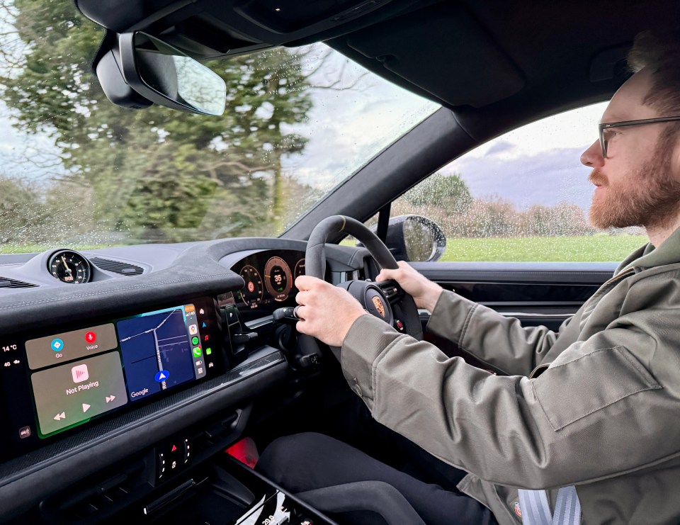 Man driving a Porsche Cayenne.